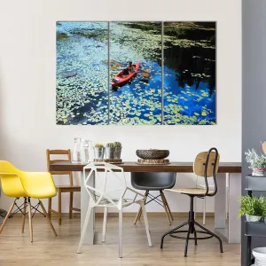 Canoeing In Water Lilies Canvas Wall Art